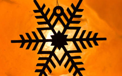 Wooden SnowFlake In Front Of Shining Salt Lamp